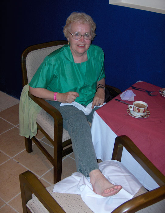 Waiter has placed Maxine's foot on chair. Oasis Beach Hotel, Cancun, Mexico