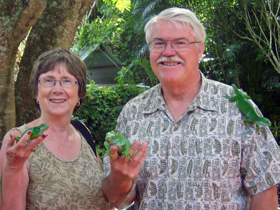 Chris and Rick Millikan pose with new friends, green crested iguanas in Fiji.  Photo courtesy of Chris and Rick Millikan