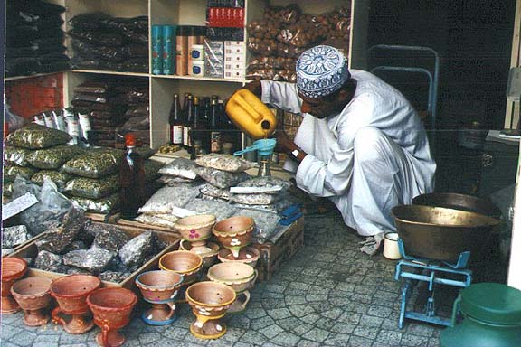 Merchant sells wares in Muttrah souk in Oman