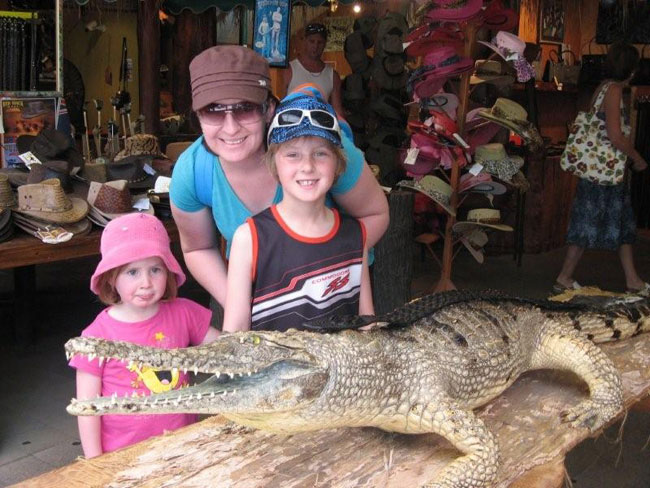 Getting up close and personal with a crocodile in North Queensland.  A novel way of advertising crocodile leather goods for sale. Photo by Heather and Barry Minton