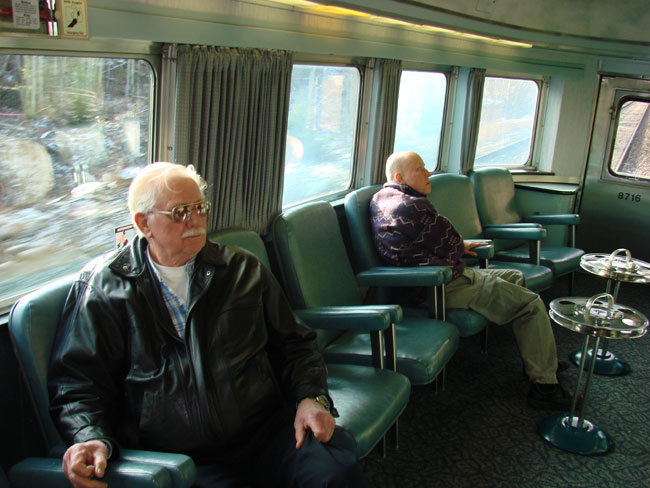 Richard George (left) sits in club car at back of VIA Rail train.  Photo by M. Maxine George