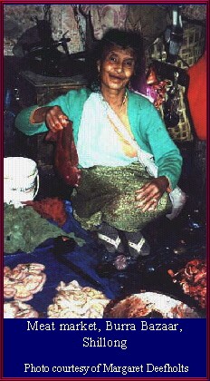 Market lady displaying meat.