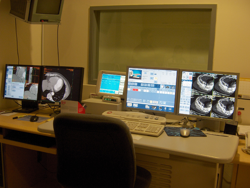 A panel of computer screens monitor a CT Scan