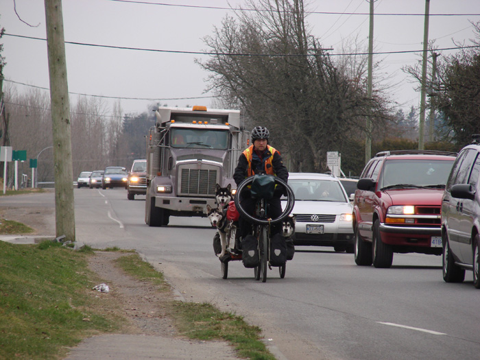 Man and dogs ride bicycle to bring his message of hope