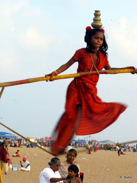 Another tightrope walker balances brass pots too on Marina Beach, Chennai.  Photo by Rick Butler
