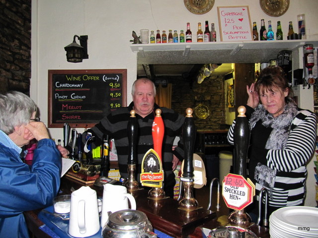Innkeepers, Geoff and Sandra Fiddler behind bar at Skirrid  Mountain Inn.   Photo by M. Maxine George